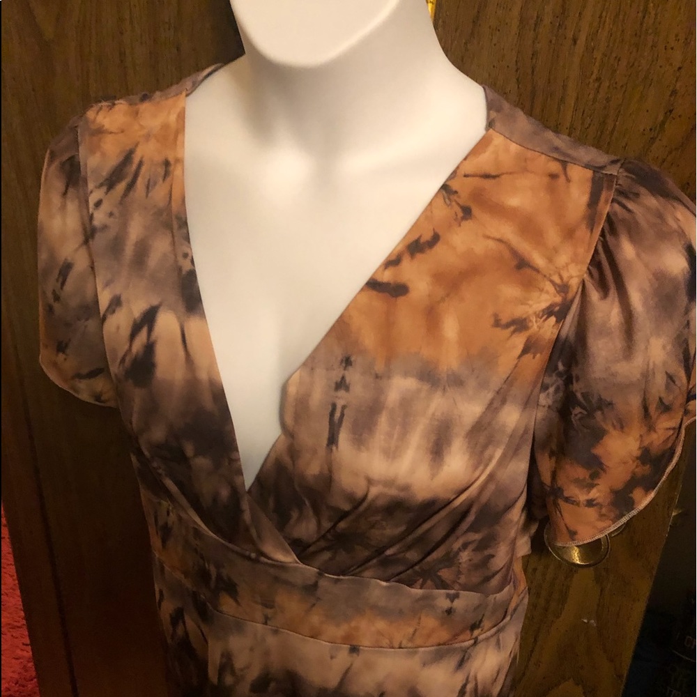 Short sleeve blouse with back open. Has a belt with it. Multi colors tiedye